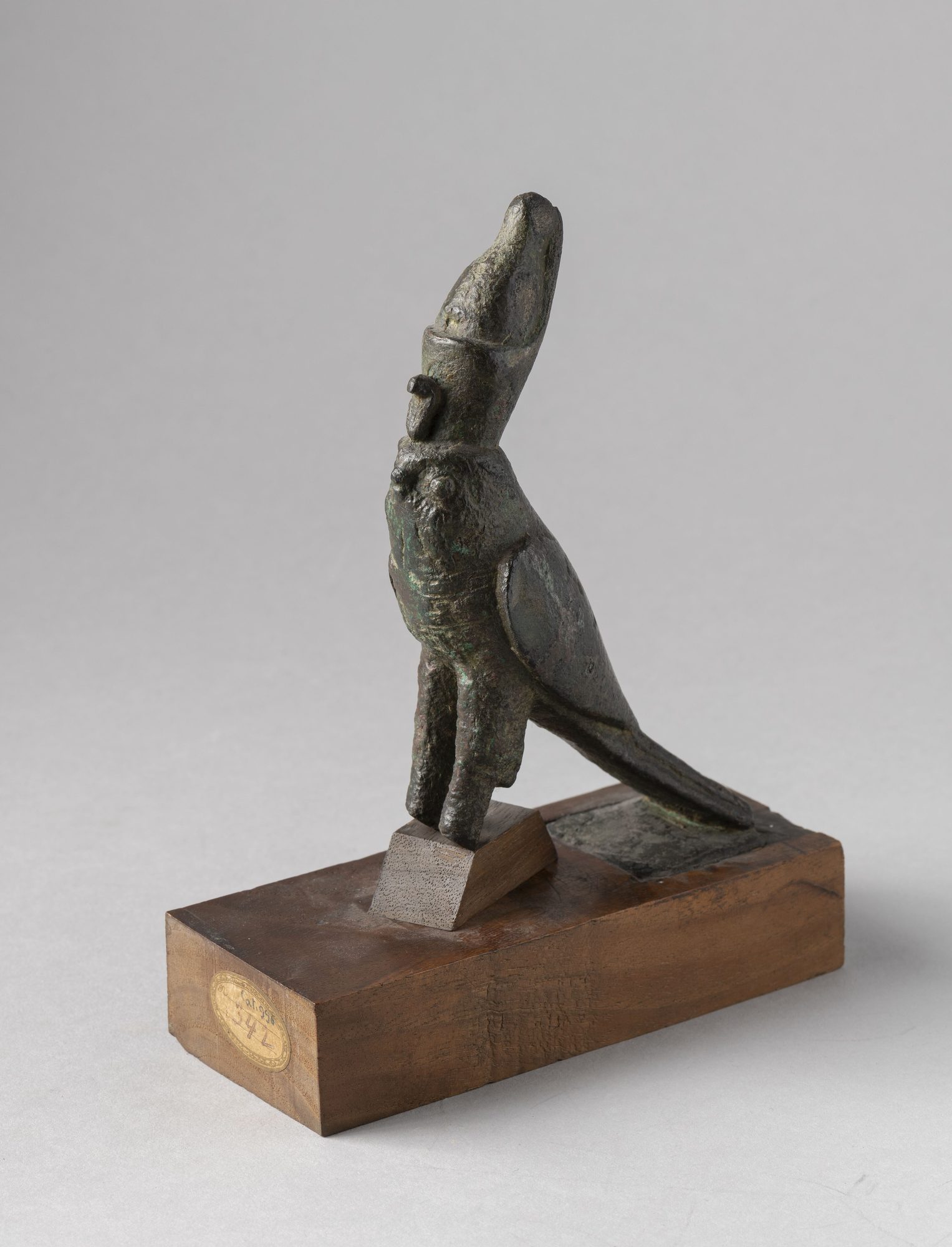 An ancient Egyptian bronze statuette of Horus as a falcon wearing the double crown of Upper and Lower Egypt.