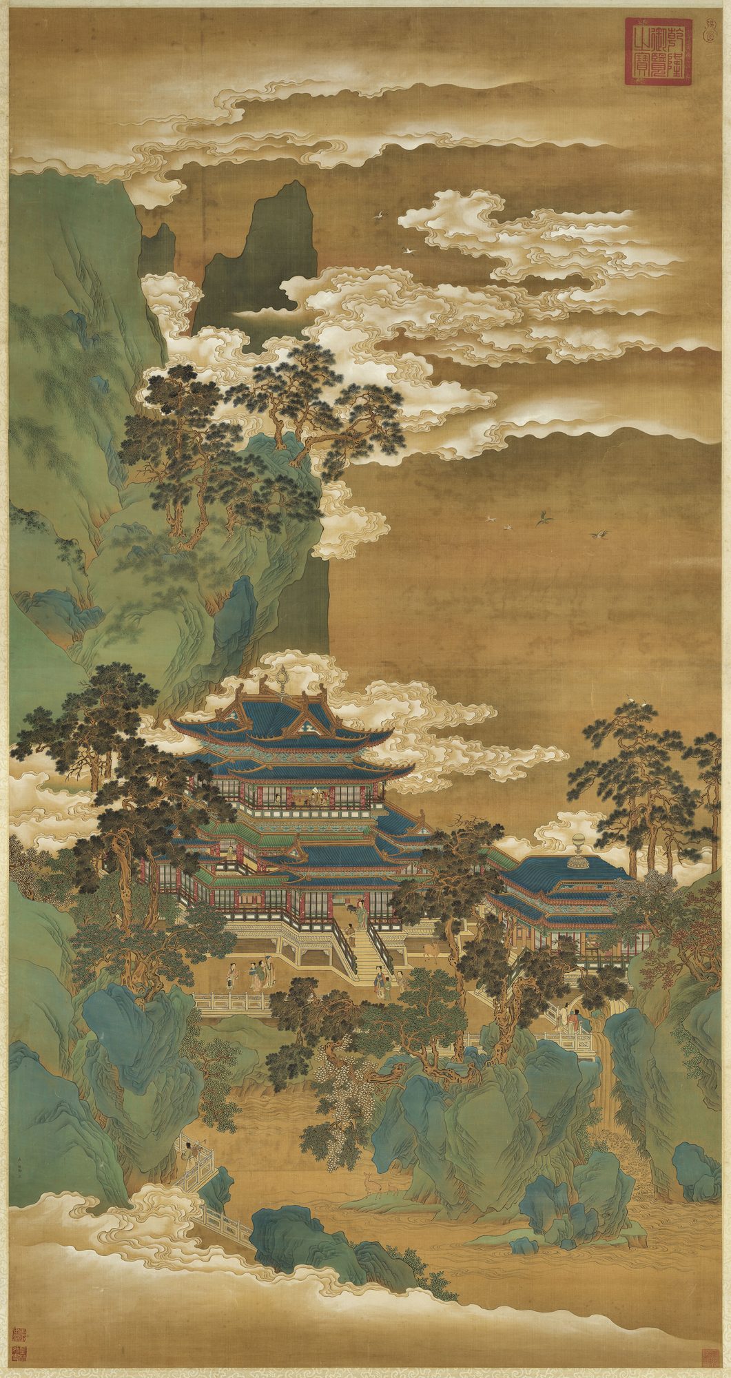 A blue-green Chinese silk landscape of an immortal mountain: jade-blue peaks wreathed in cloud rising above a many-tiered celestial palace with red pillars, blue-tiled roofs and jade balustrades, cranes in flight, deer among the rocks, and tiny figures climbing stone stairs and crossing bridges toward the heights.