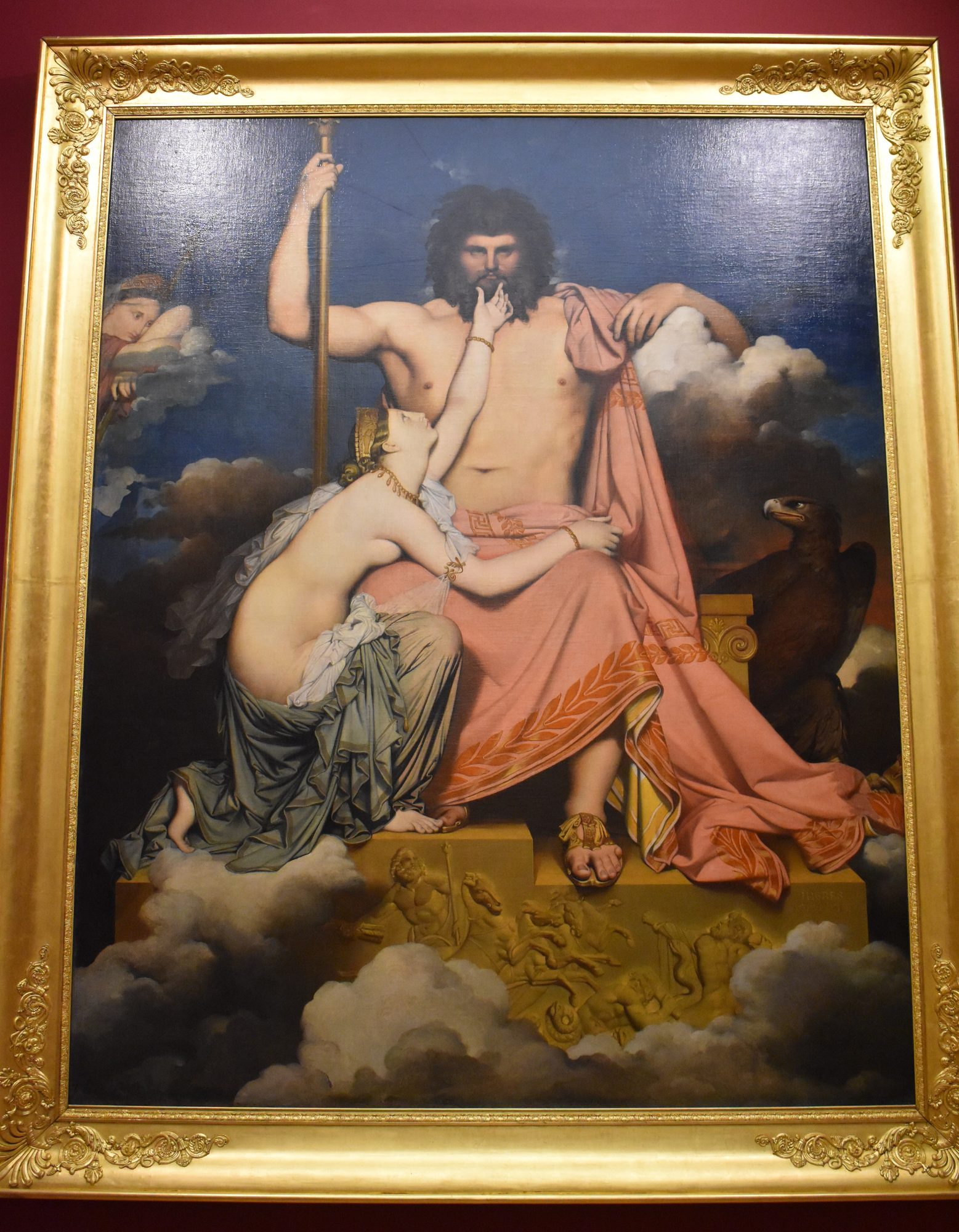 Zeus enthroned among the clouds, sceptre in hand and his eagle beside him, as the sea-nymph Thetis kneels in supplication at his knee